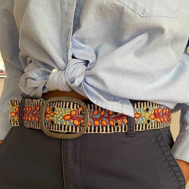 Embroidered belt with a large buckle.