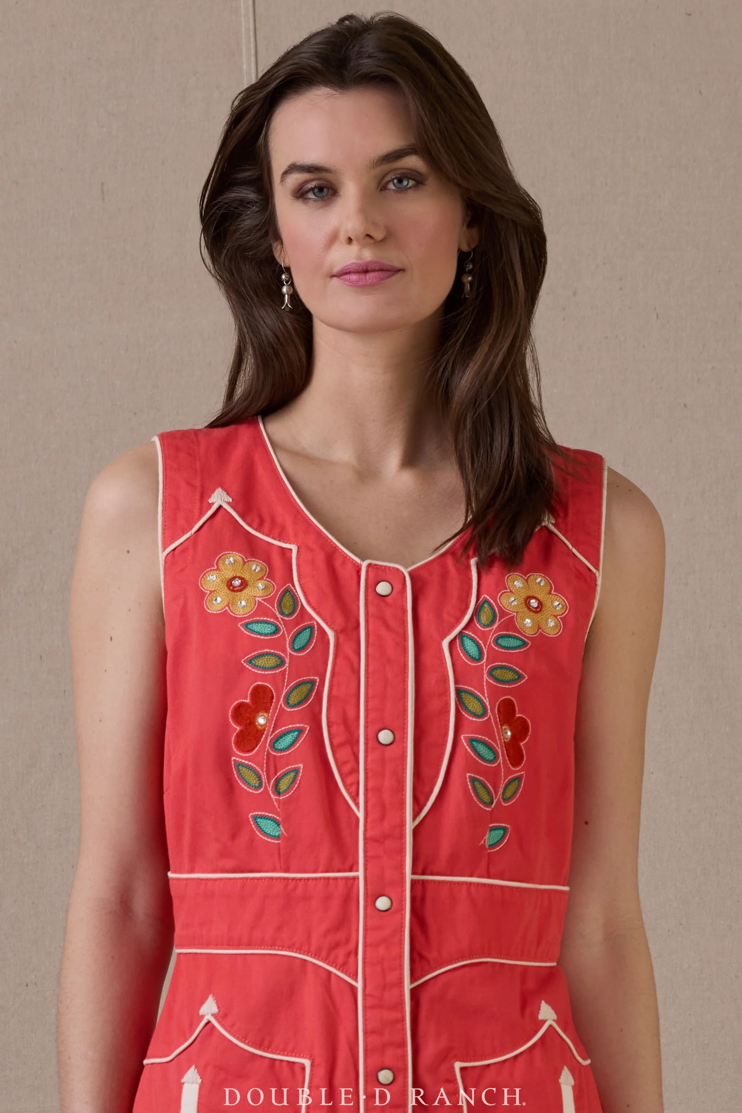 Woman in red In The Wings dress with floral embroidery