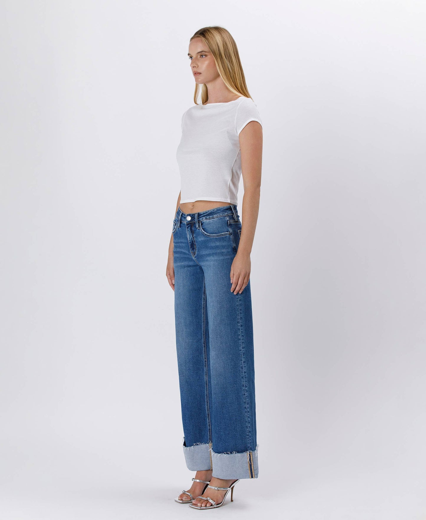 Woman in white top and blue jeans.