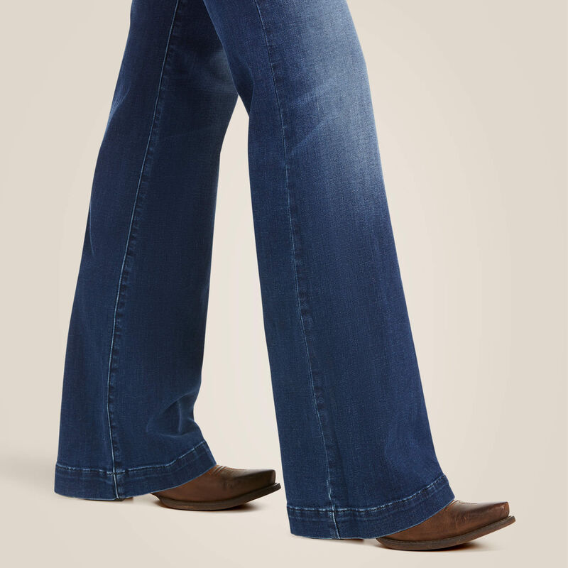 Blue denim bell-bottom jeans and brown shoes.