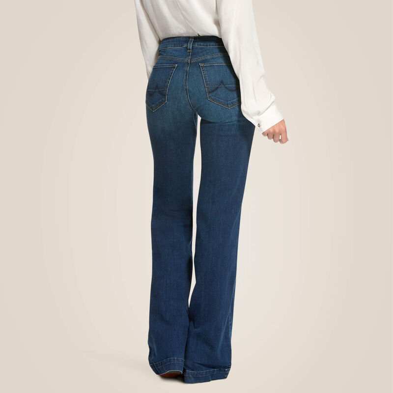 Woman wearing blue denim wide-leg jeans and white shirt.