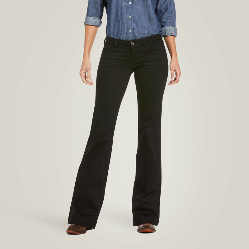 Woman wearing black bell-bottom jeans and a blue shirt.