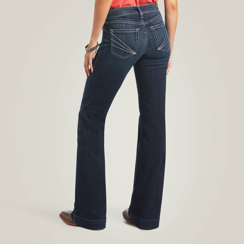 Woman wearing dark wash flared jeans.