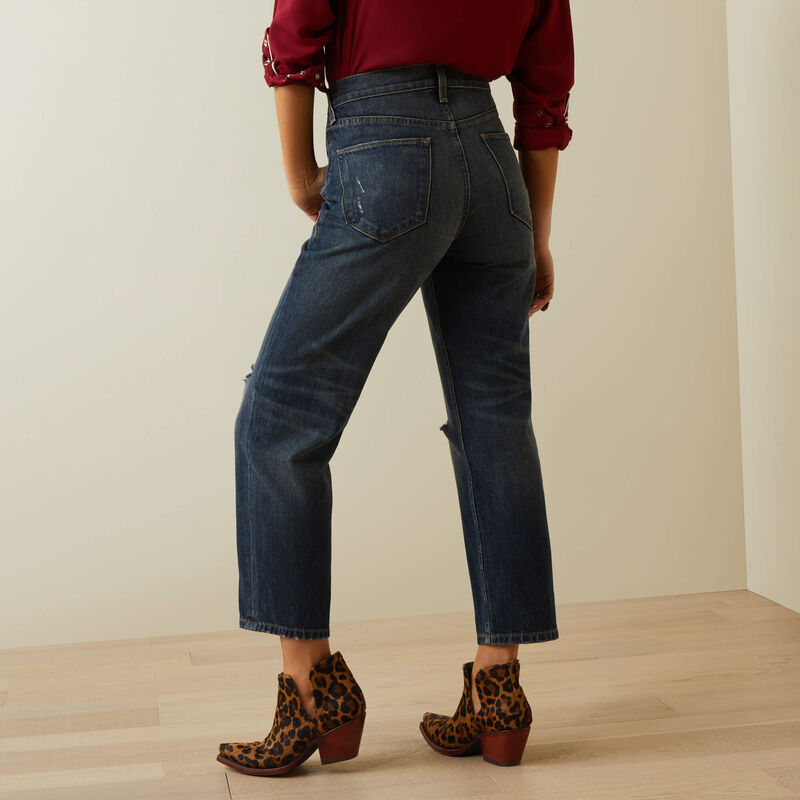 Woman in jeans and leopard print boots.