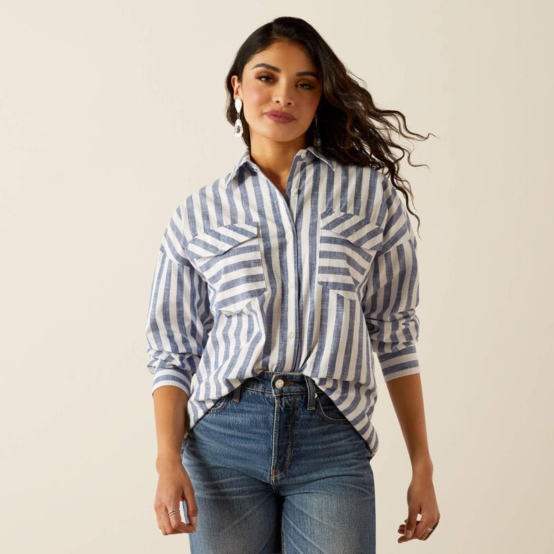 Woman wearing blue and white striped shirt and jeans.