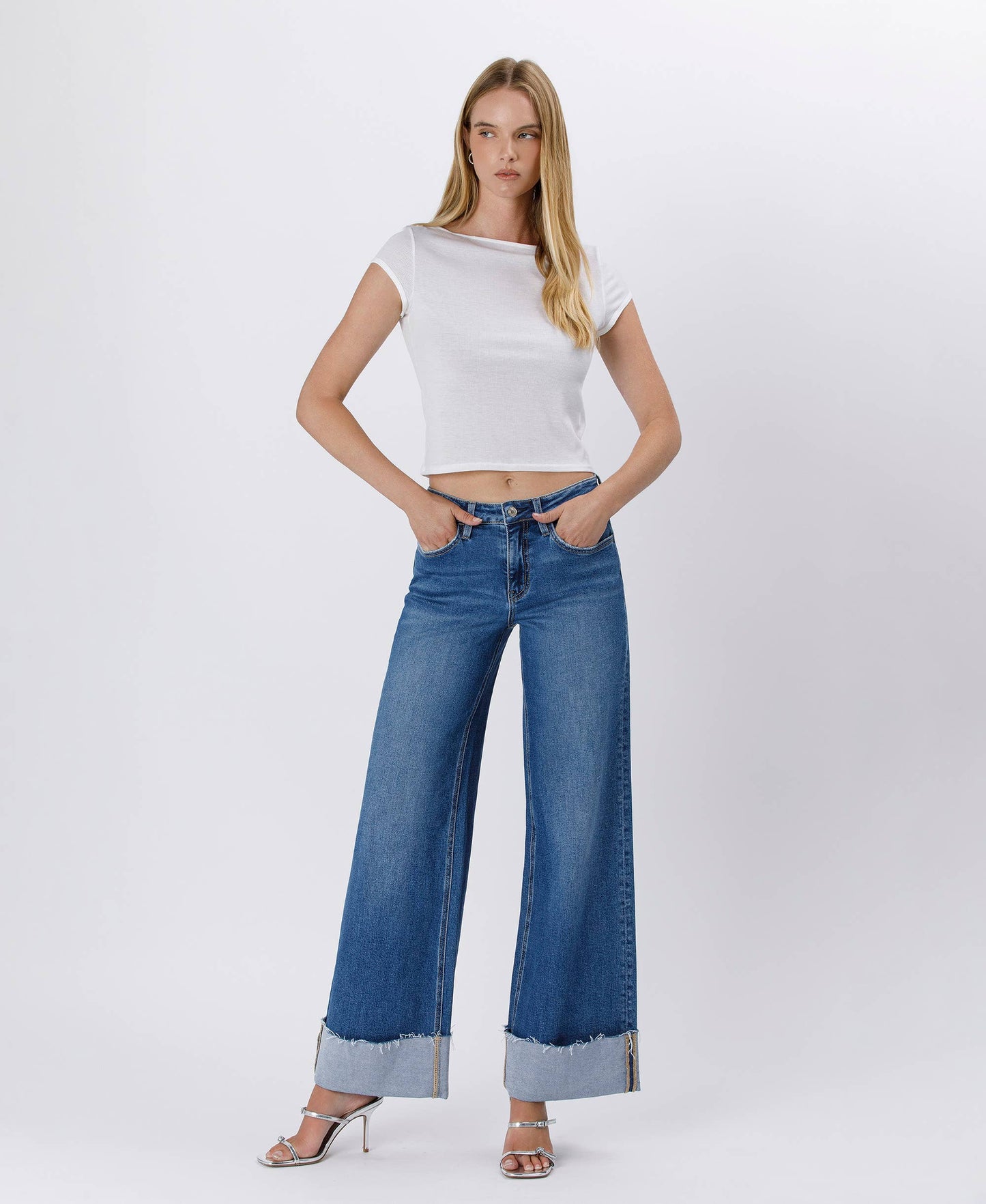 Woman in white top and blue jeans.