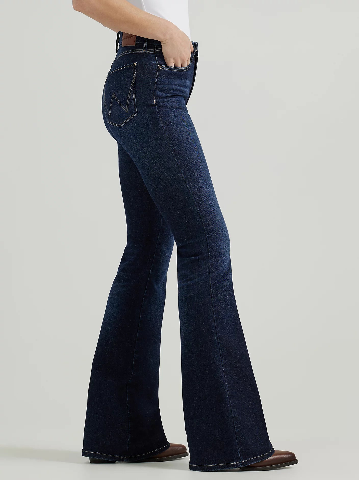 Woman wearing dark wash flared jeans.