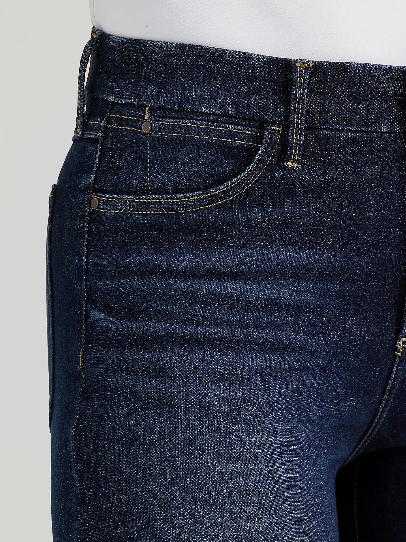 Close-up of dark blue denim jeans with pocket detail.