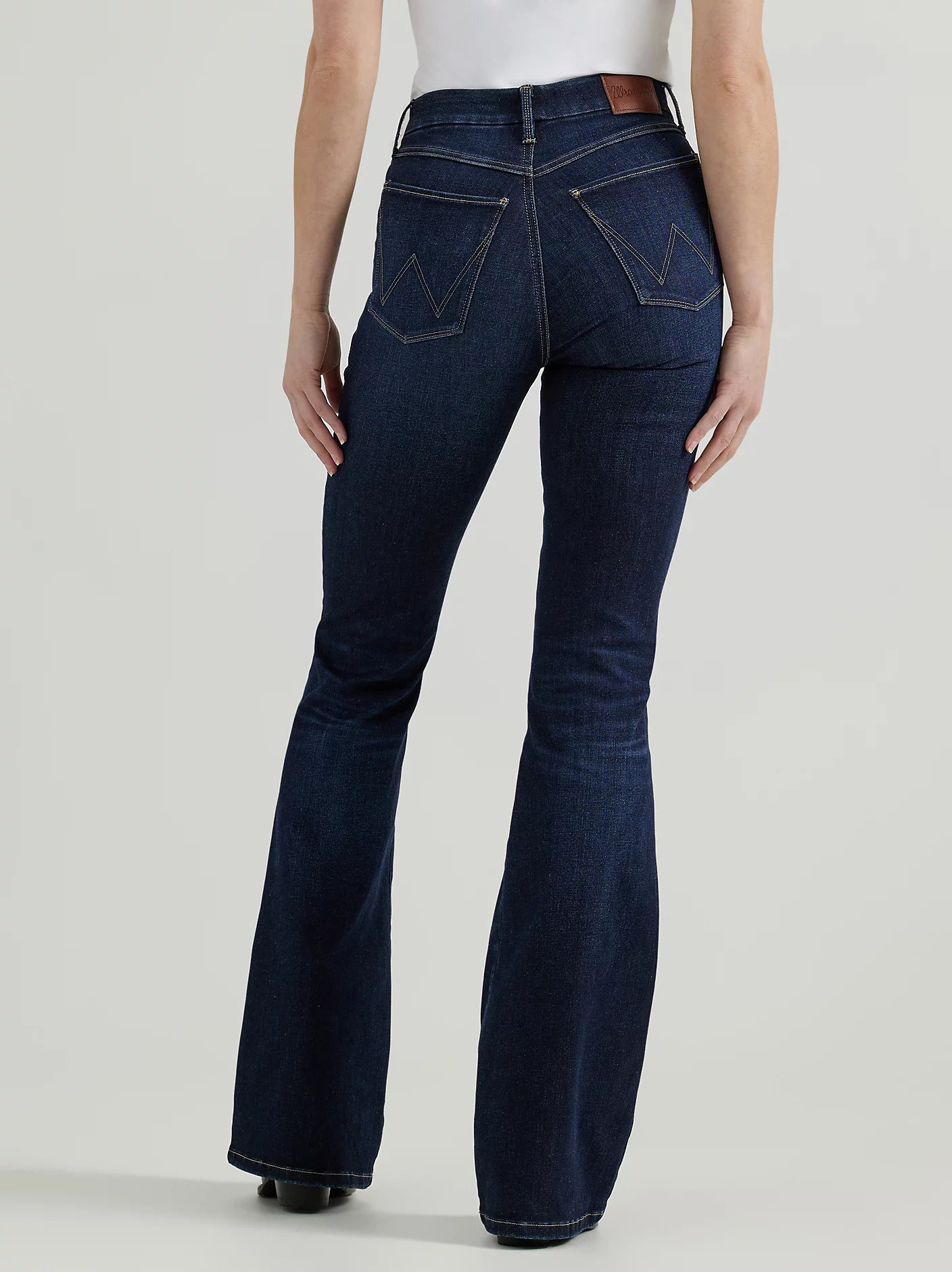 Woman wearing dark wash flared jeans.
