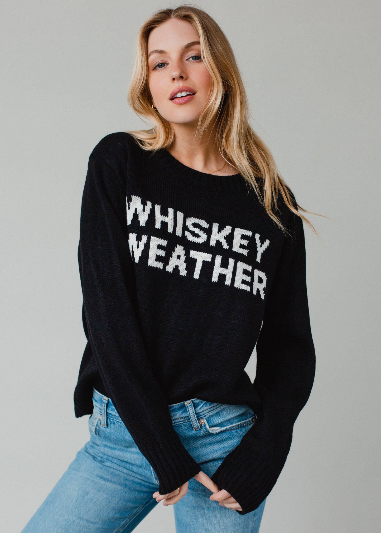 Woman in black sweater with Whiskey Weather text.