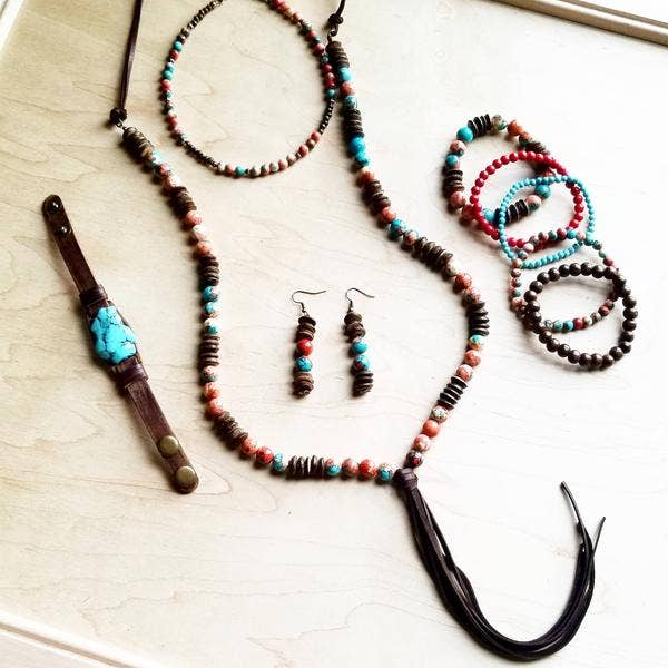 Jewelry set with necklace, bracelets, earrings, and bracelet.