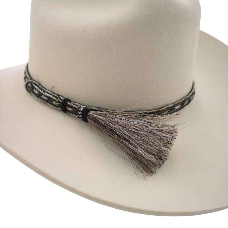Beige cowboy hat with a braided band and tassel.