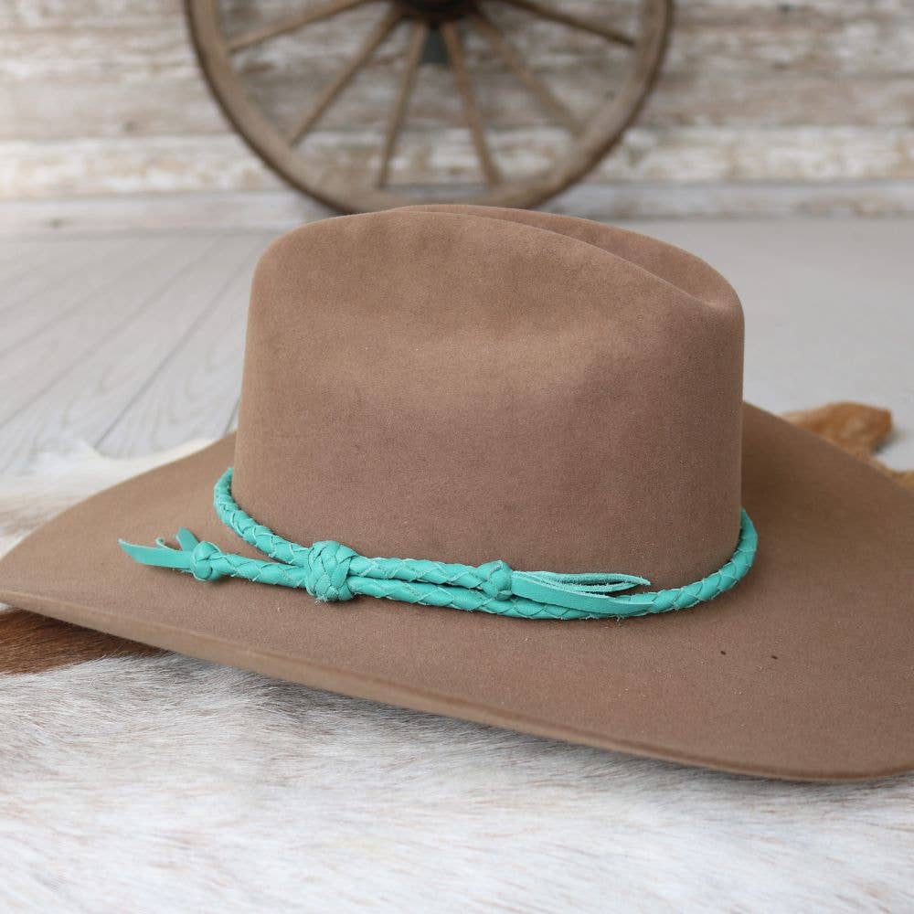 Brown cowboy hat with turquoise band.