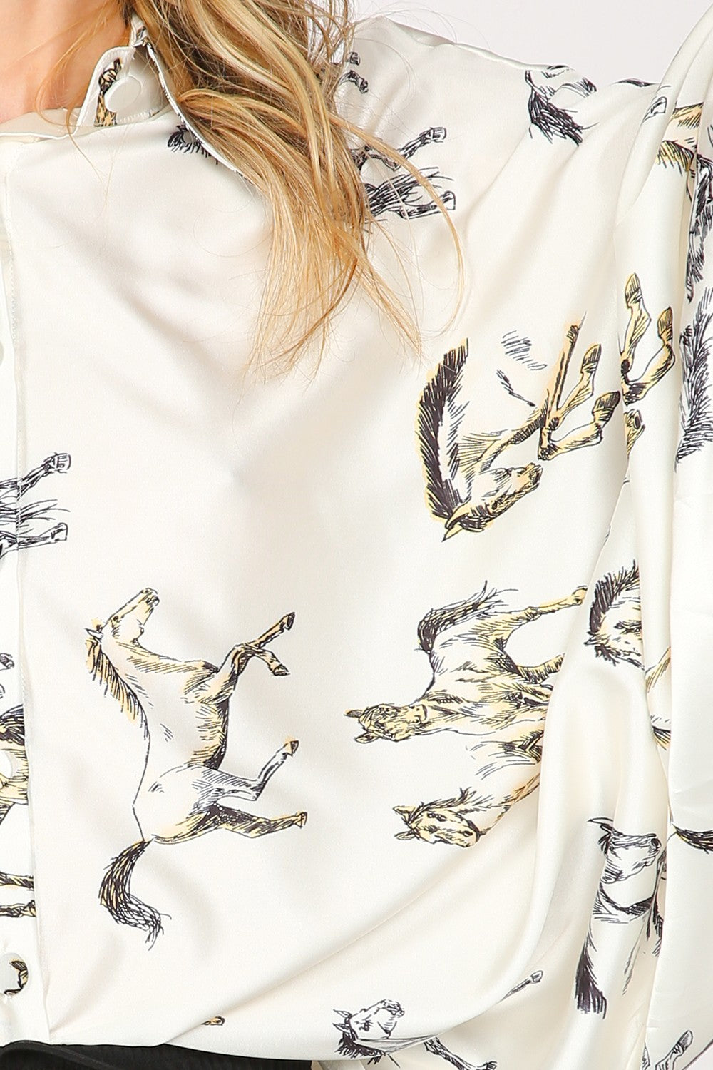 Woman wearing a white shirt with horse print.