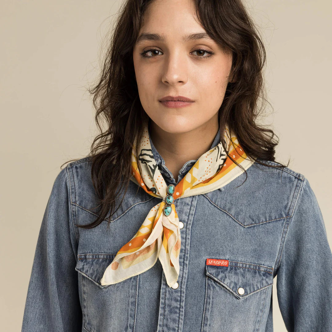 FW23 Studio Model wearing patterned scarf and denim shirt.