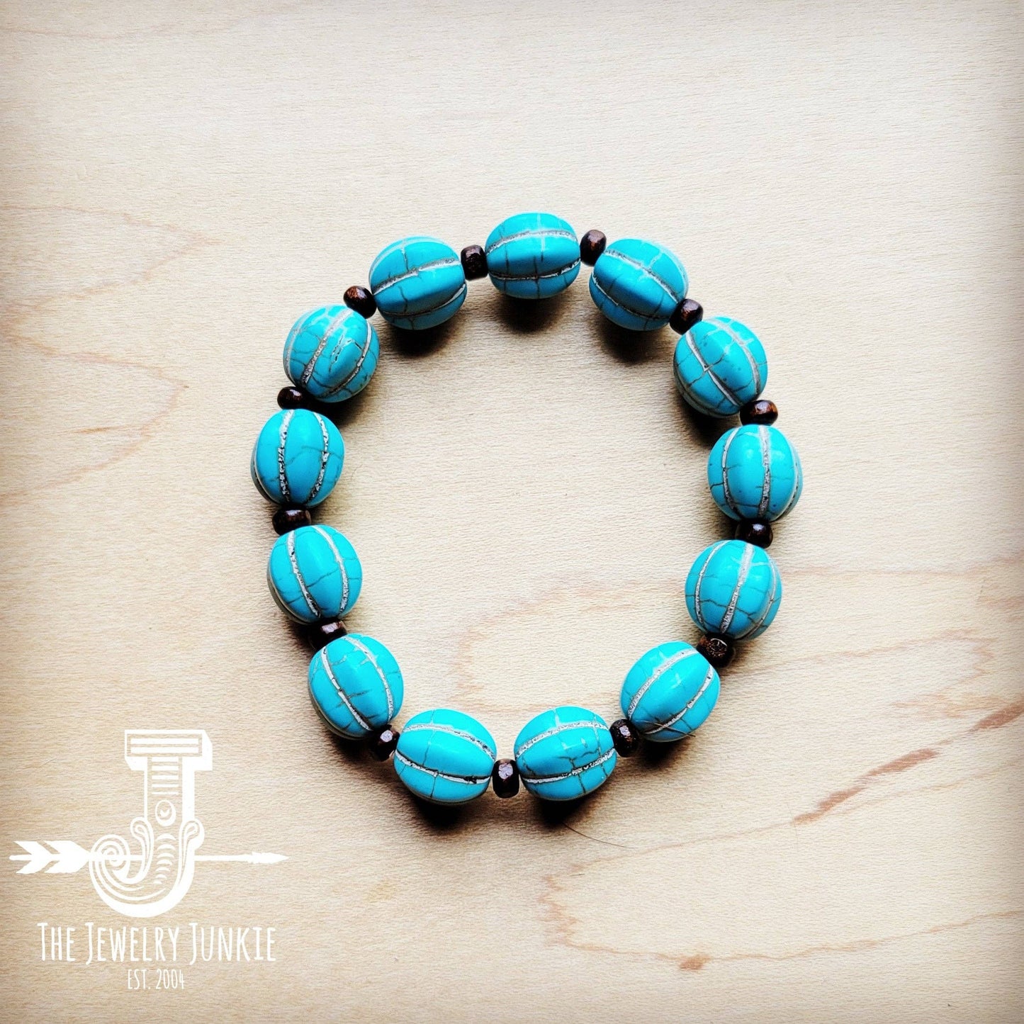 Turquoise beaded bracelet on wood surface.