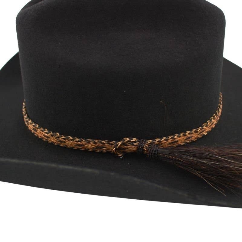 Black cowboy hat with decorative band and tassel.