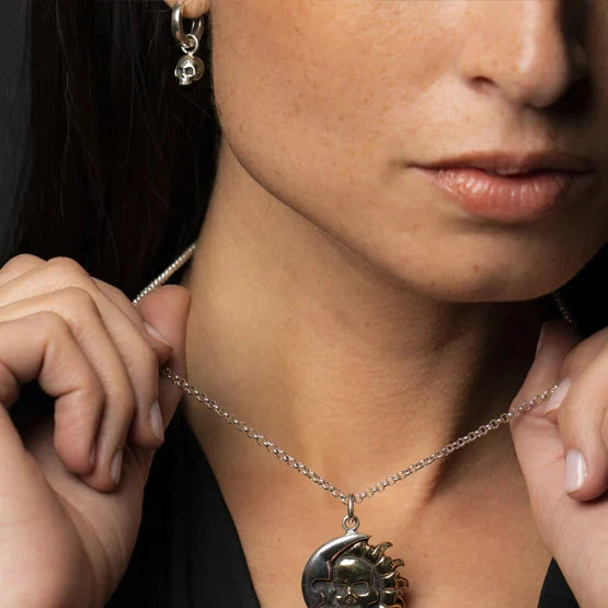 Woman wearing skull jewelry, necklace, and earring