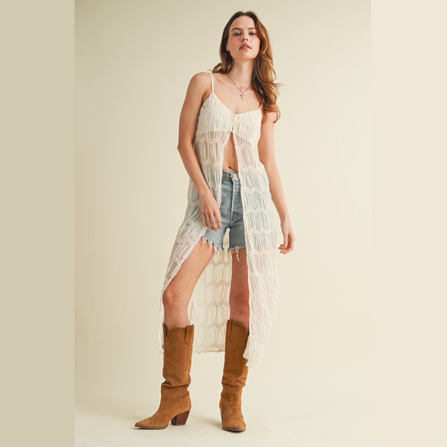 Woman wearing dress, shorts, and boots.