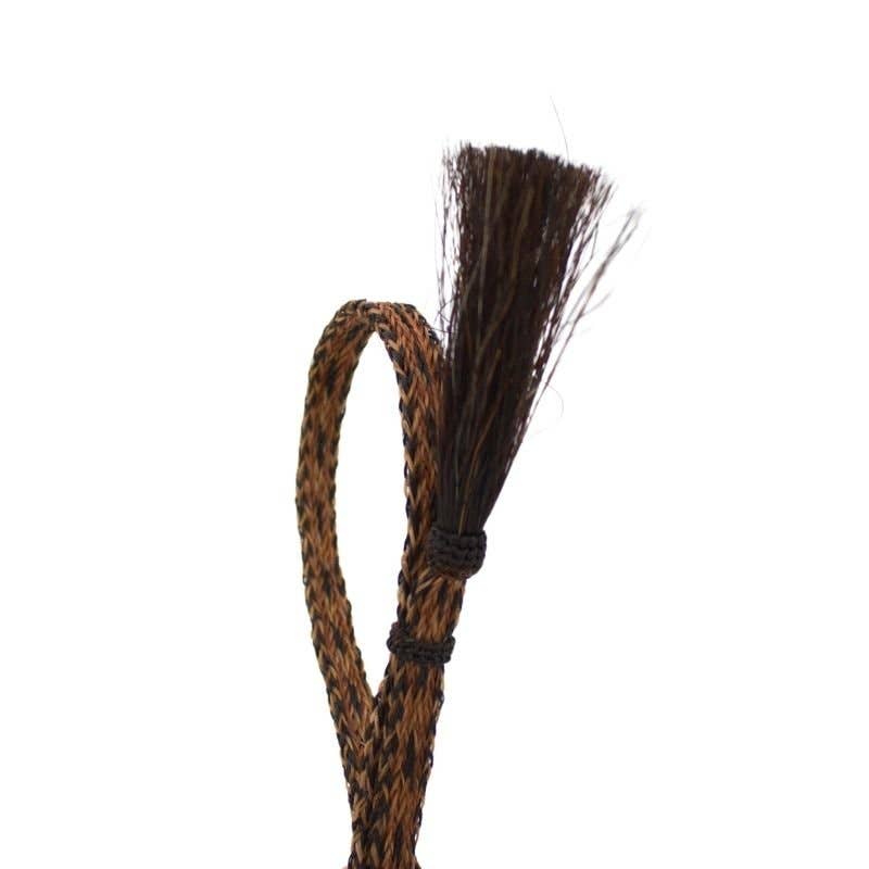 Braided horsehair with frayed end.