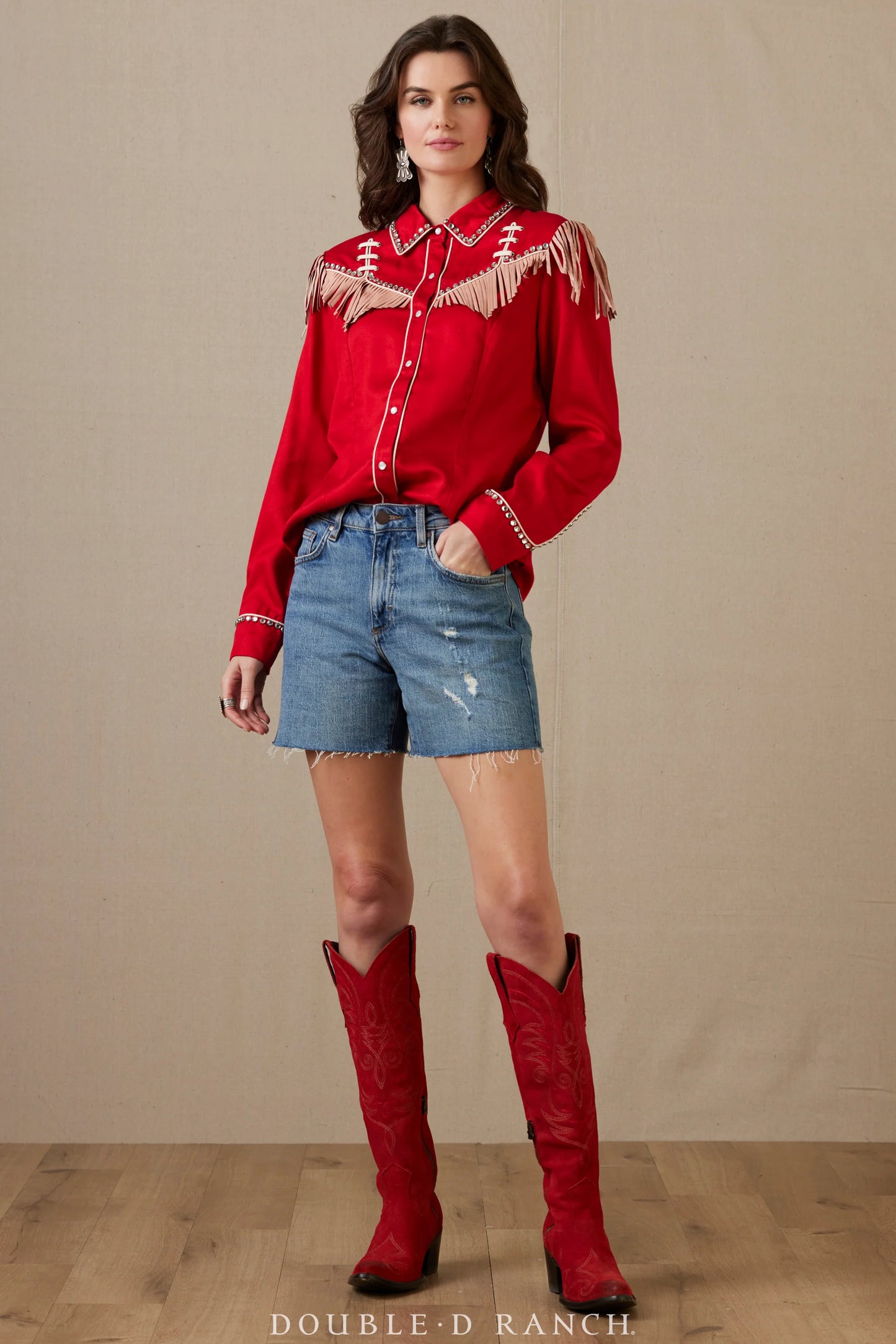 Woman in red rodeo top and denim shorts