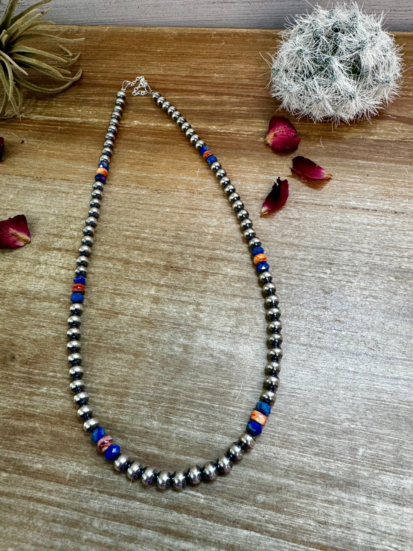 Silver beaded necklace with blue and orange accents