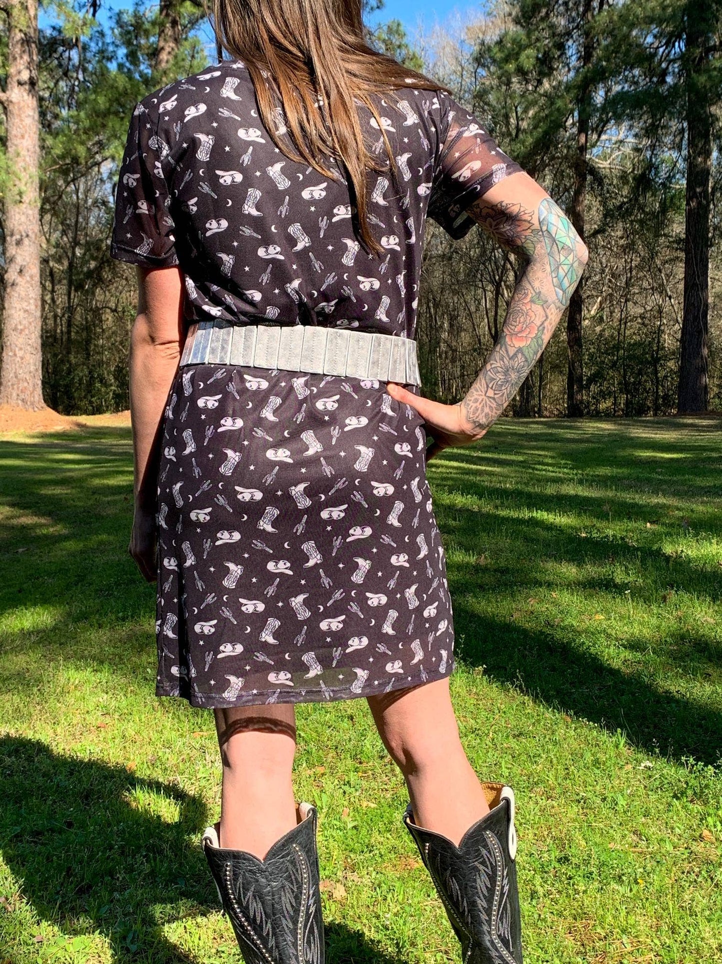 Woman in black dress with boots print.