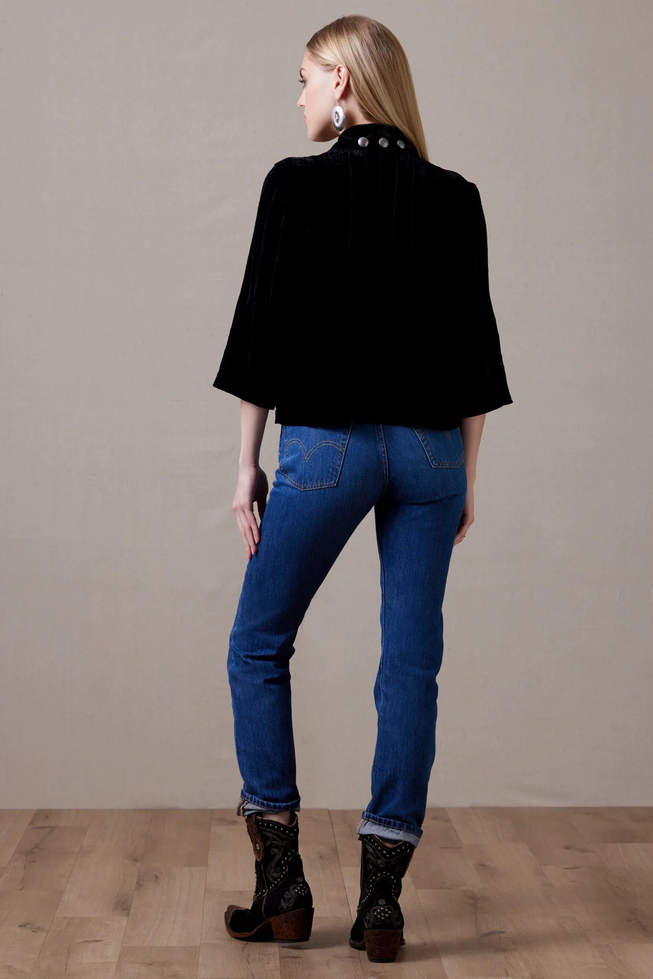 Daughter of the Moon top, woman in black cape & jeans
