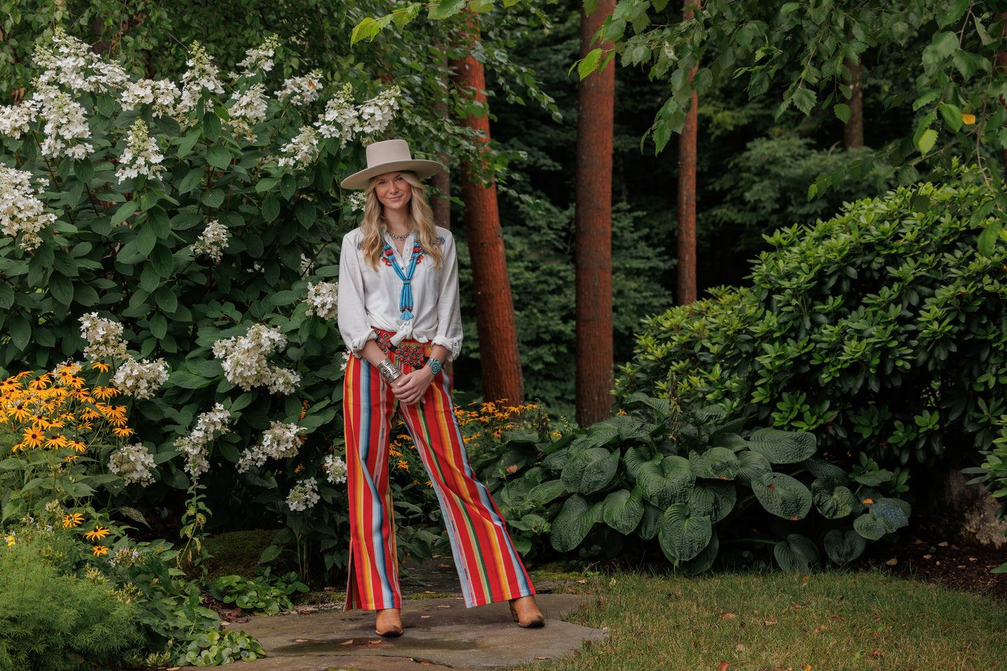 Woman in Winnie shirt and Lyla pants in garden