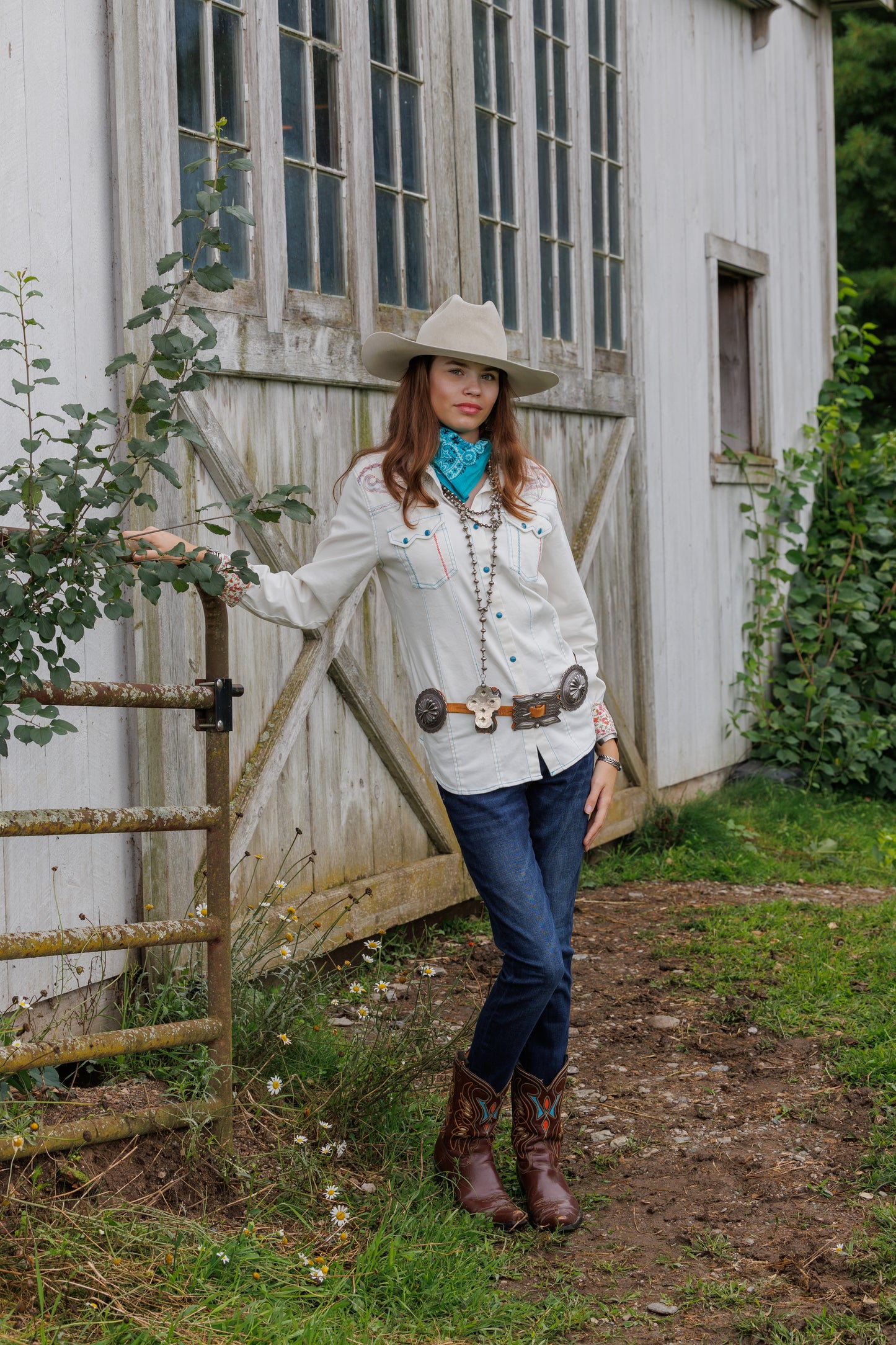 Woman in Rebel Shirt, jeans, and cowboy boots.