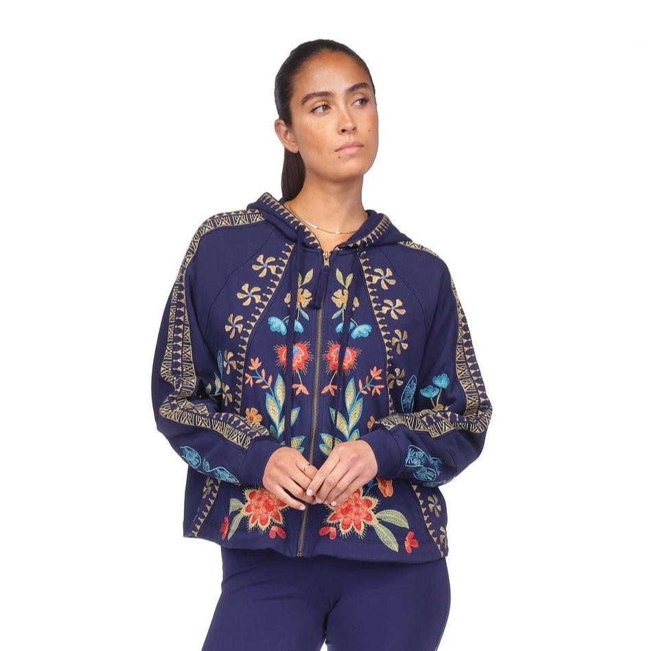 Woman wearing a navy floral embroidered hoodie