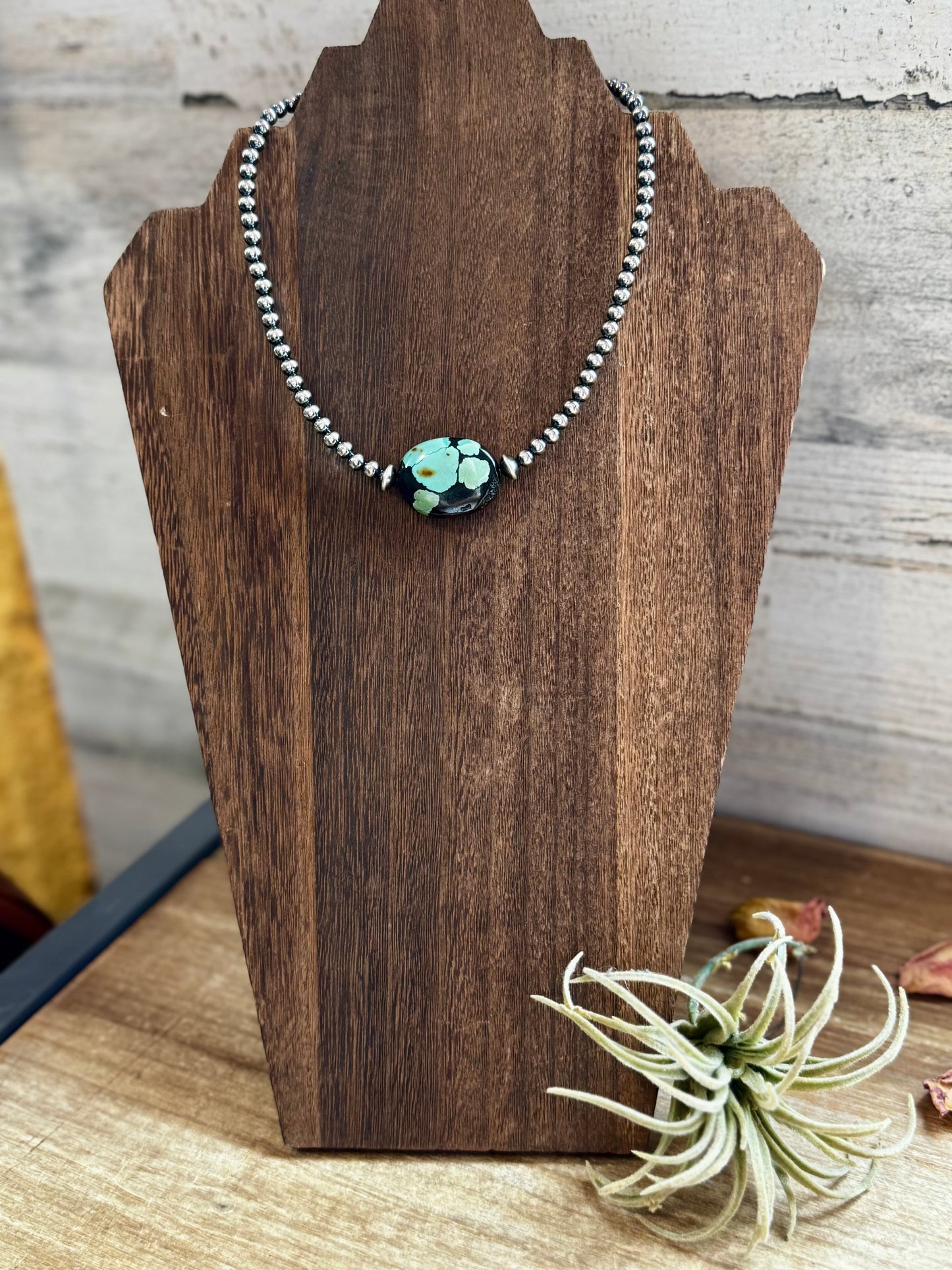 Turquoise bead necklace on display - 3FF793D9-0E07-46D7