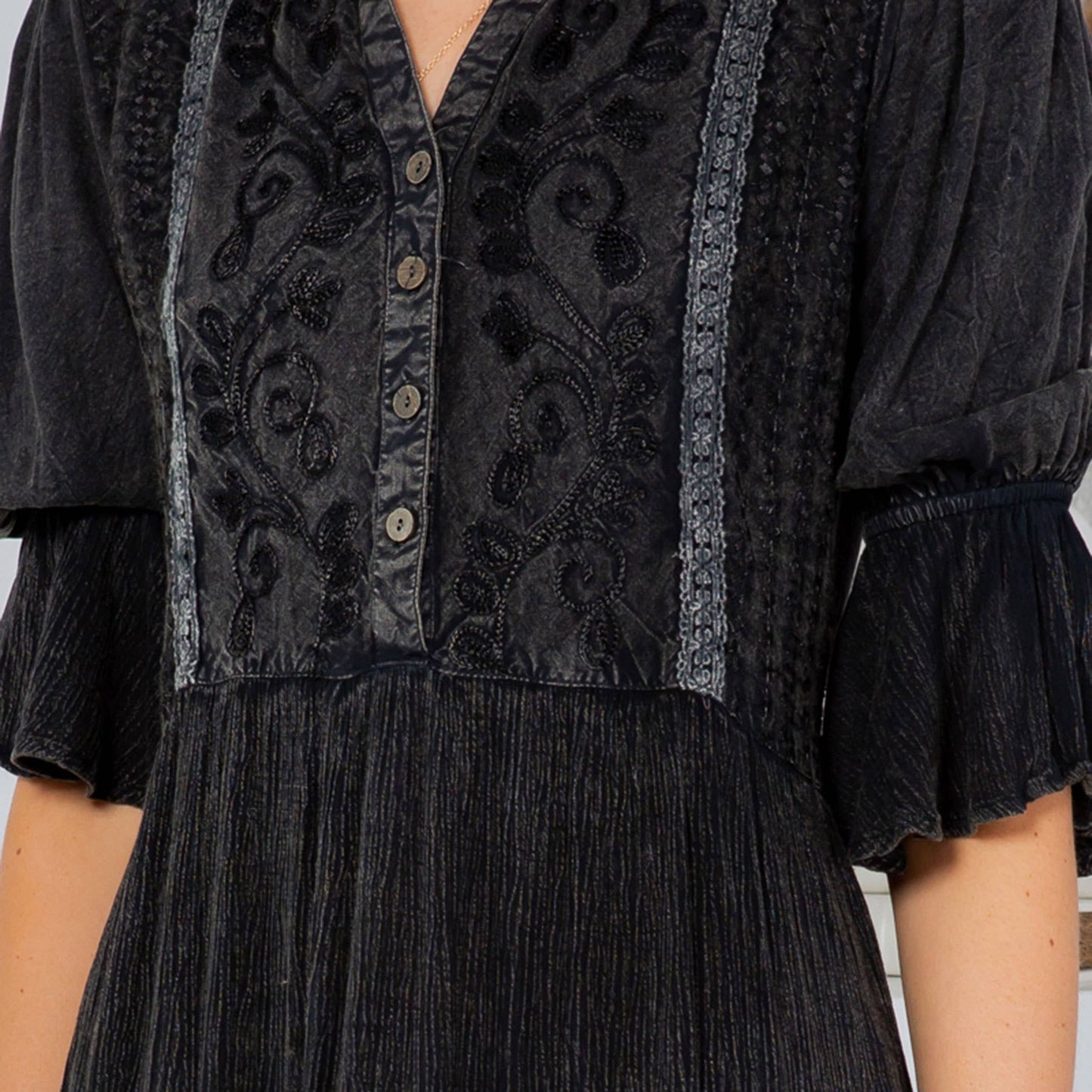 Black dress with floral embroidery.