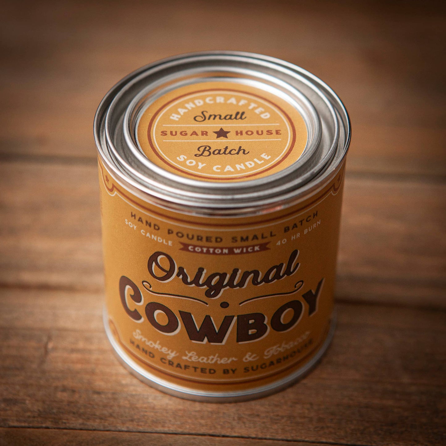 Cowboy soy candle in a metal can.