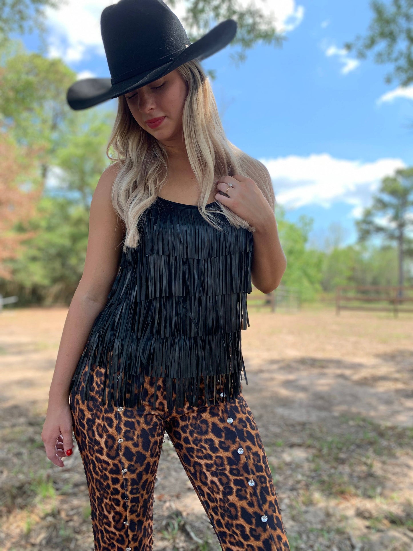 Woman in black fringe top and leopard pants