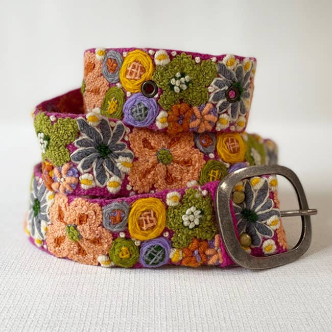 Embroidered floral belt with a metal buckle.