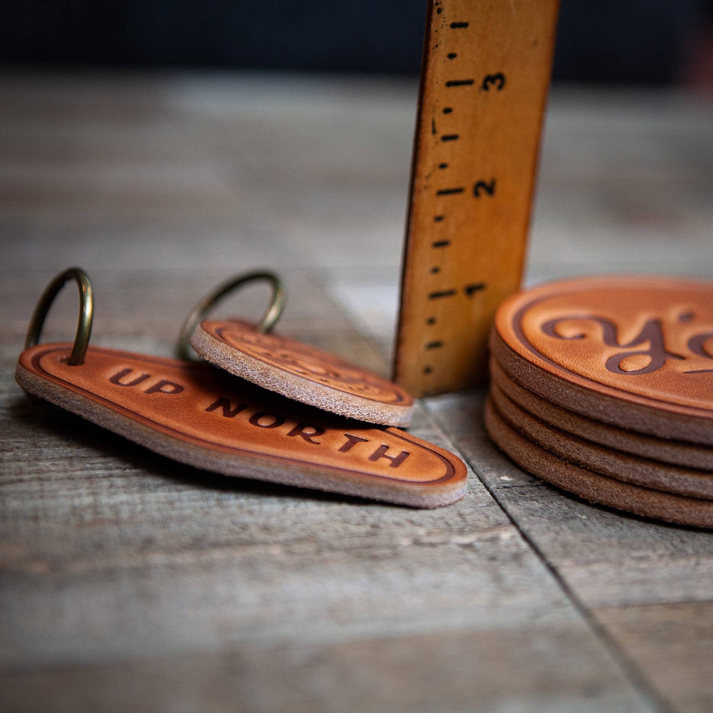Leather keychains and coasters with Up North text