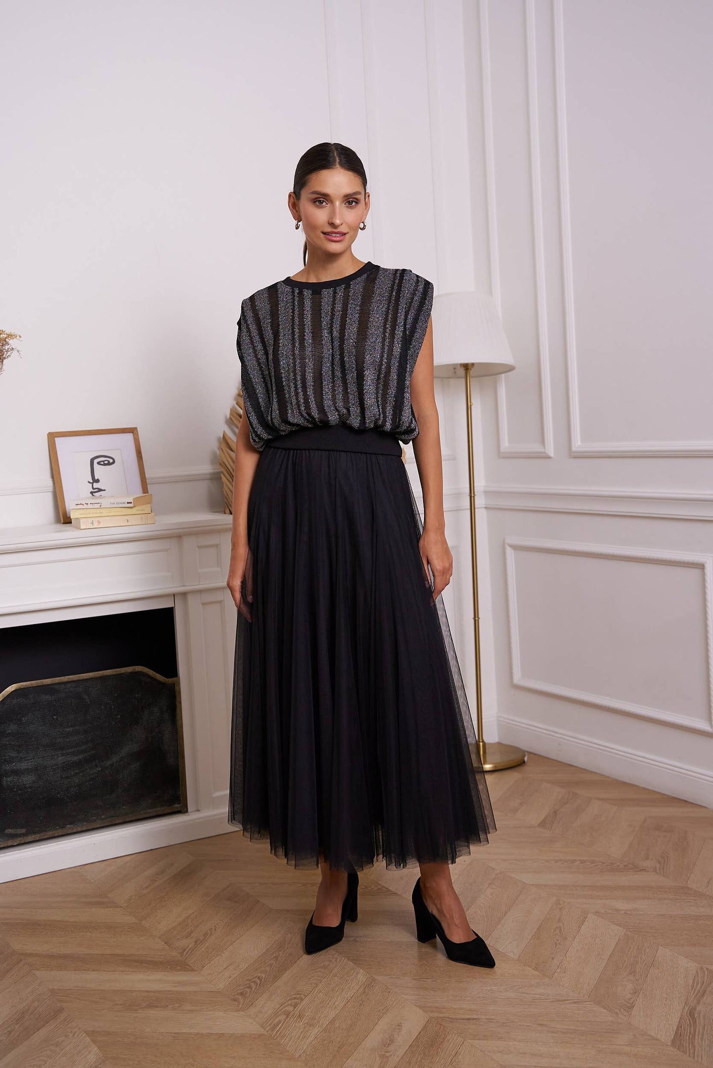 Woman in black skirt and top, fashion image.