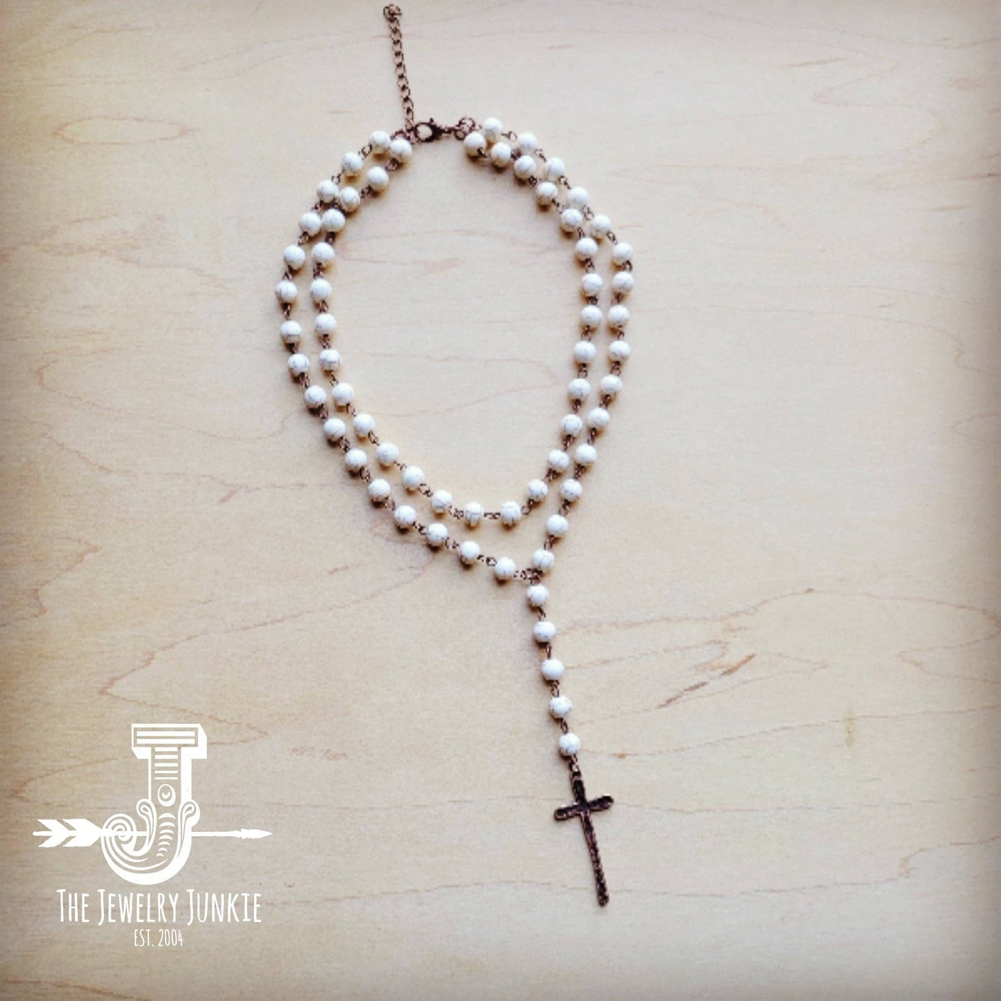 Pearl bead necklace with cross pendant.