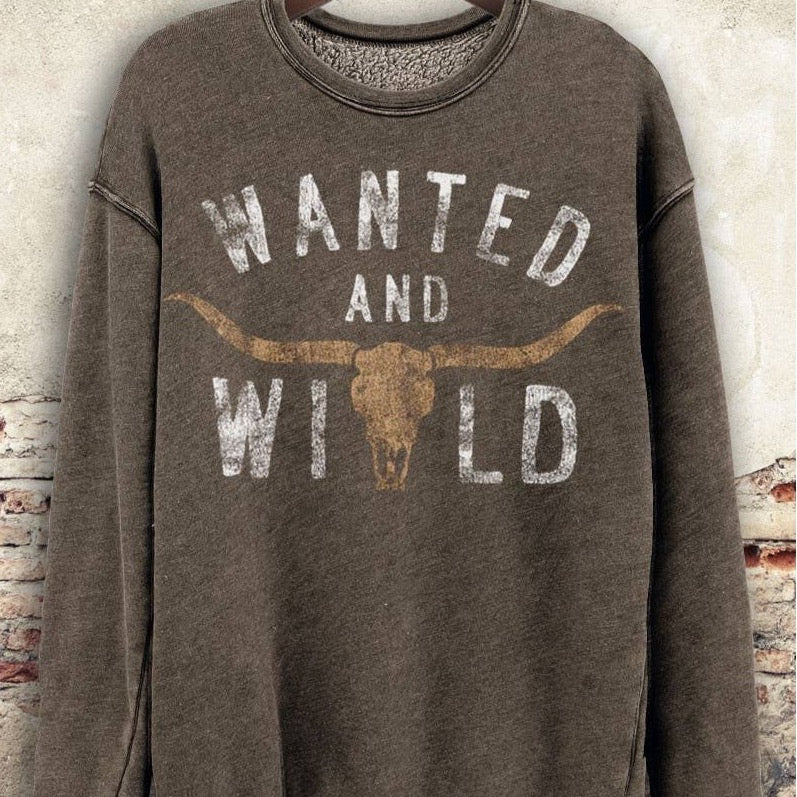 Brown sweatshirt with WANTED AND WILD text and bull skull graphic.