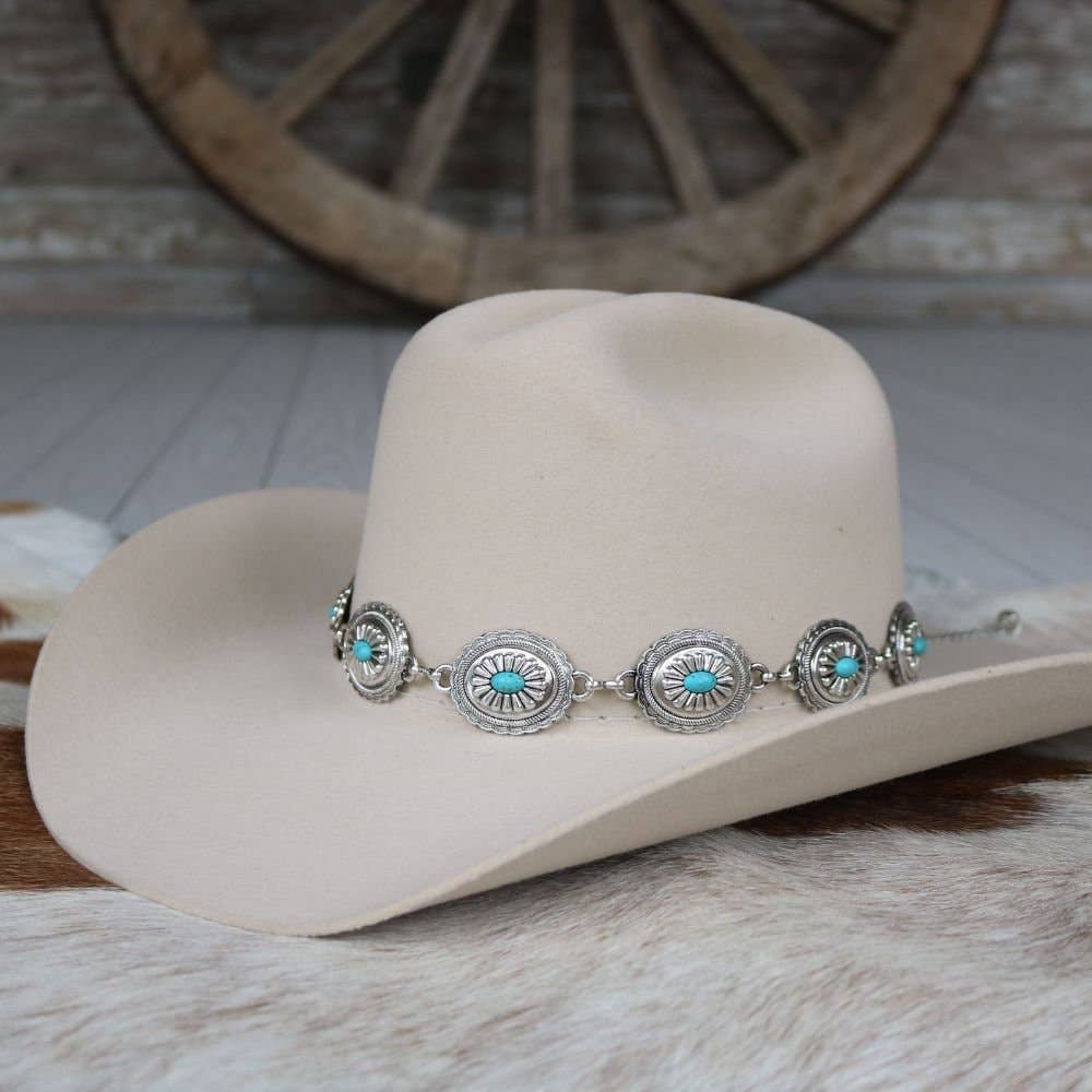Beige cowboy hat with turquoise and silver band.