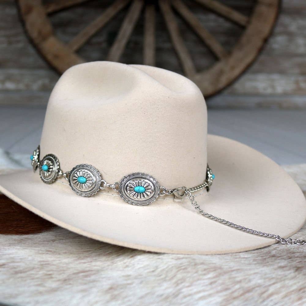 Cream-colored cowboy hat with turquoise and silver embellishments.