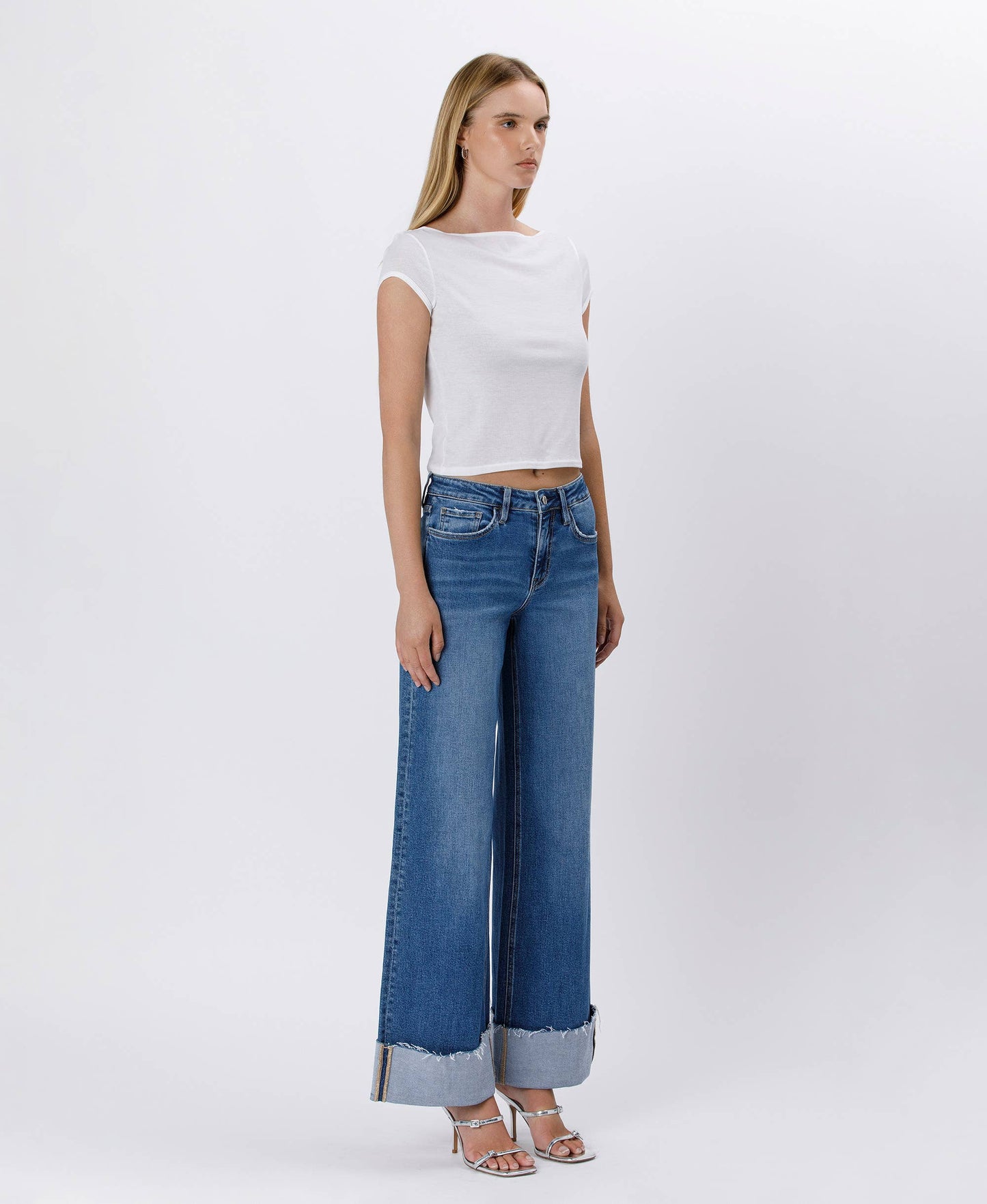 Woman in white top and jeans.