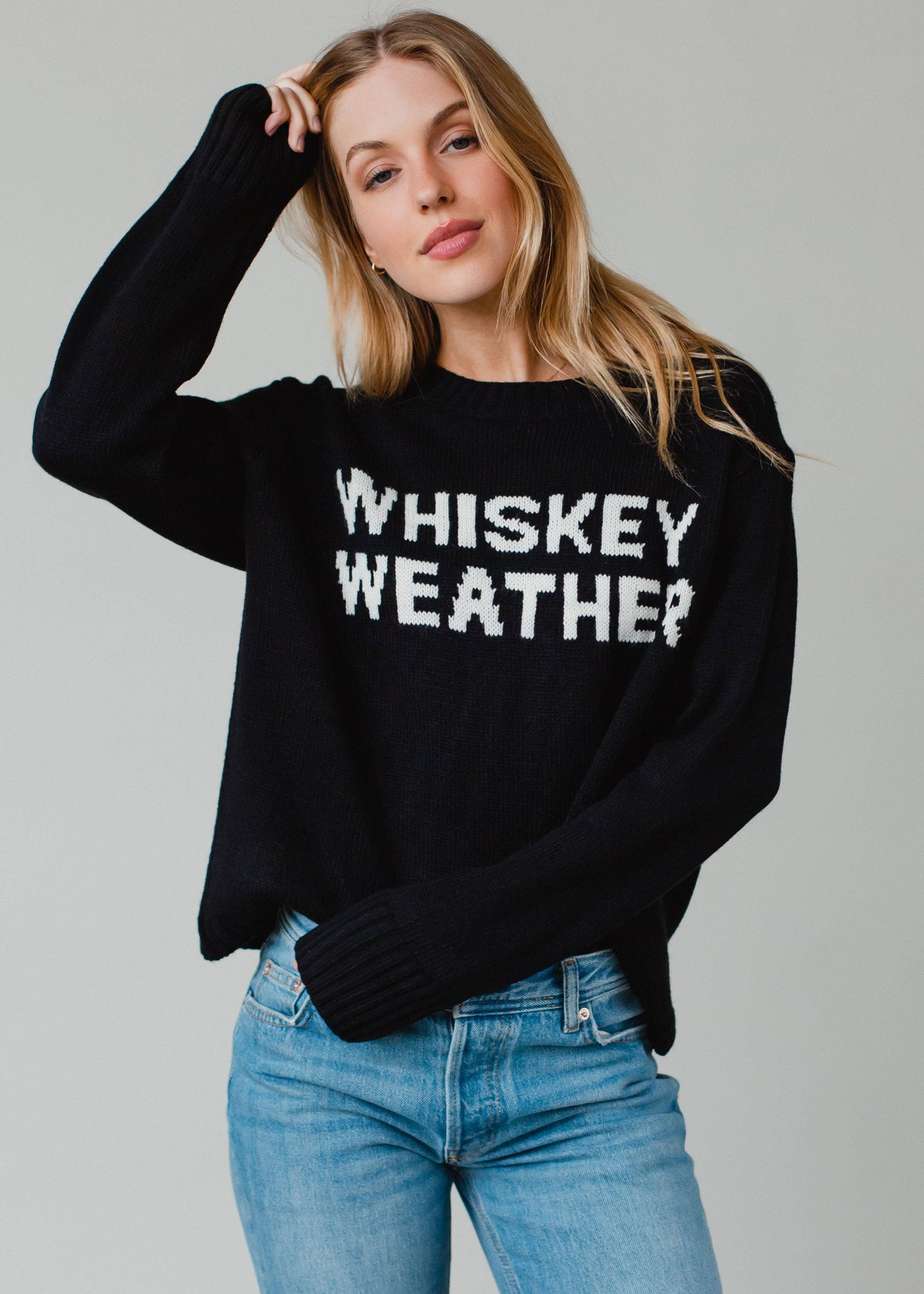 Woman in black sweater with Whiskey Weather text.