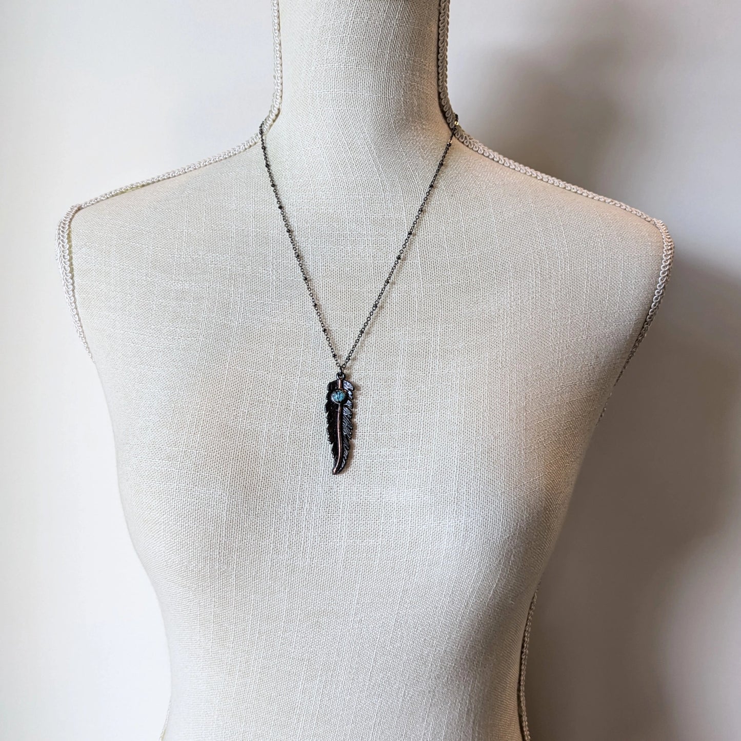 Feather necklace on mannequin