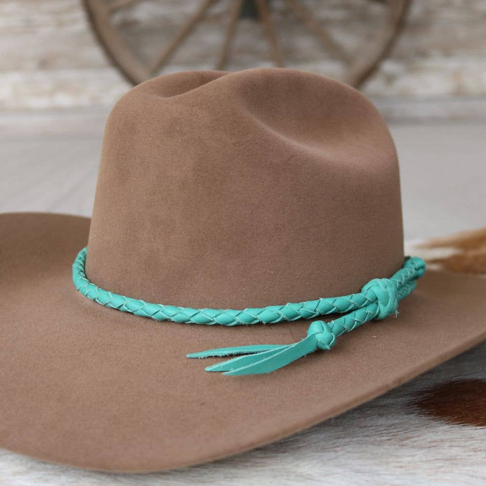 Brown cowboy hat with turquoise braided band.