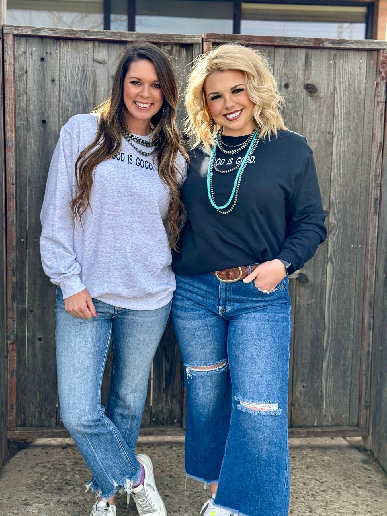 Two women wearing God is Good shirts