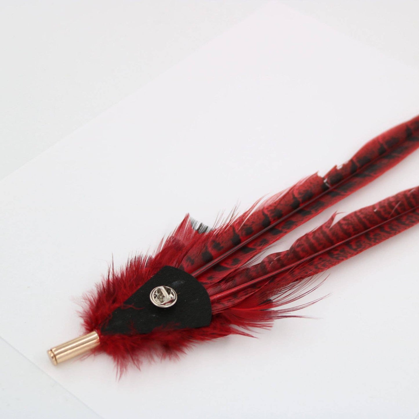 Red feather lapel pin