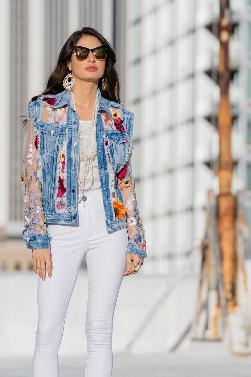 Woman in floral denim jacket and white pants
