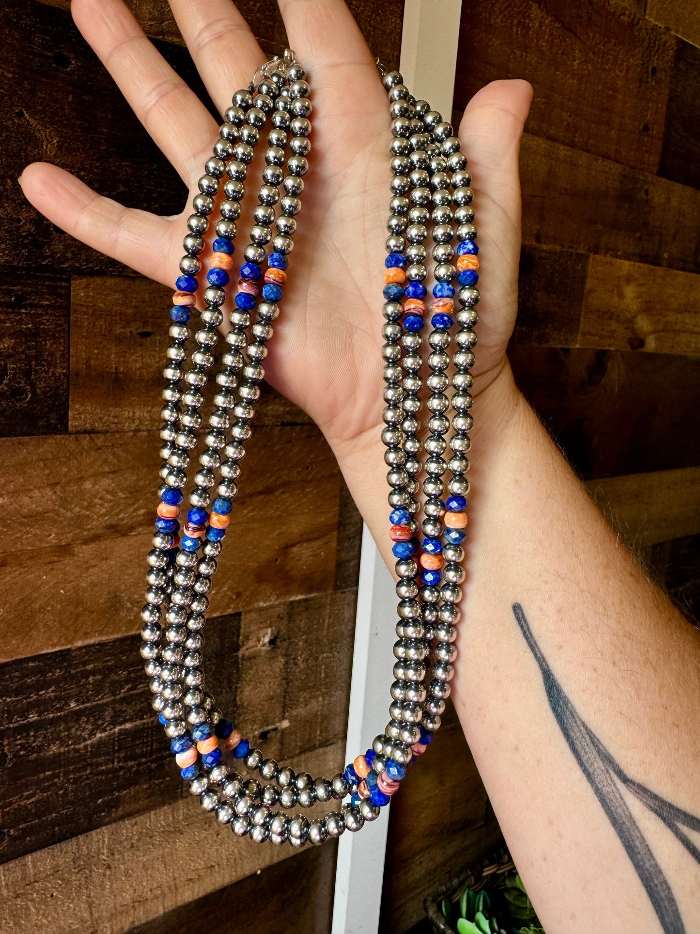 Silver beaded necklace with blue & orange accents